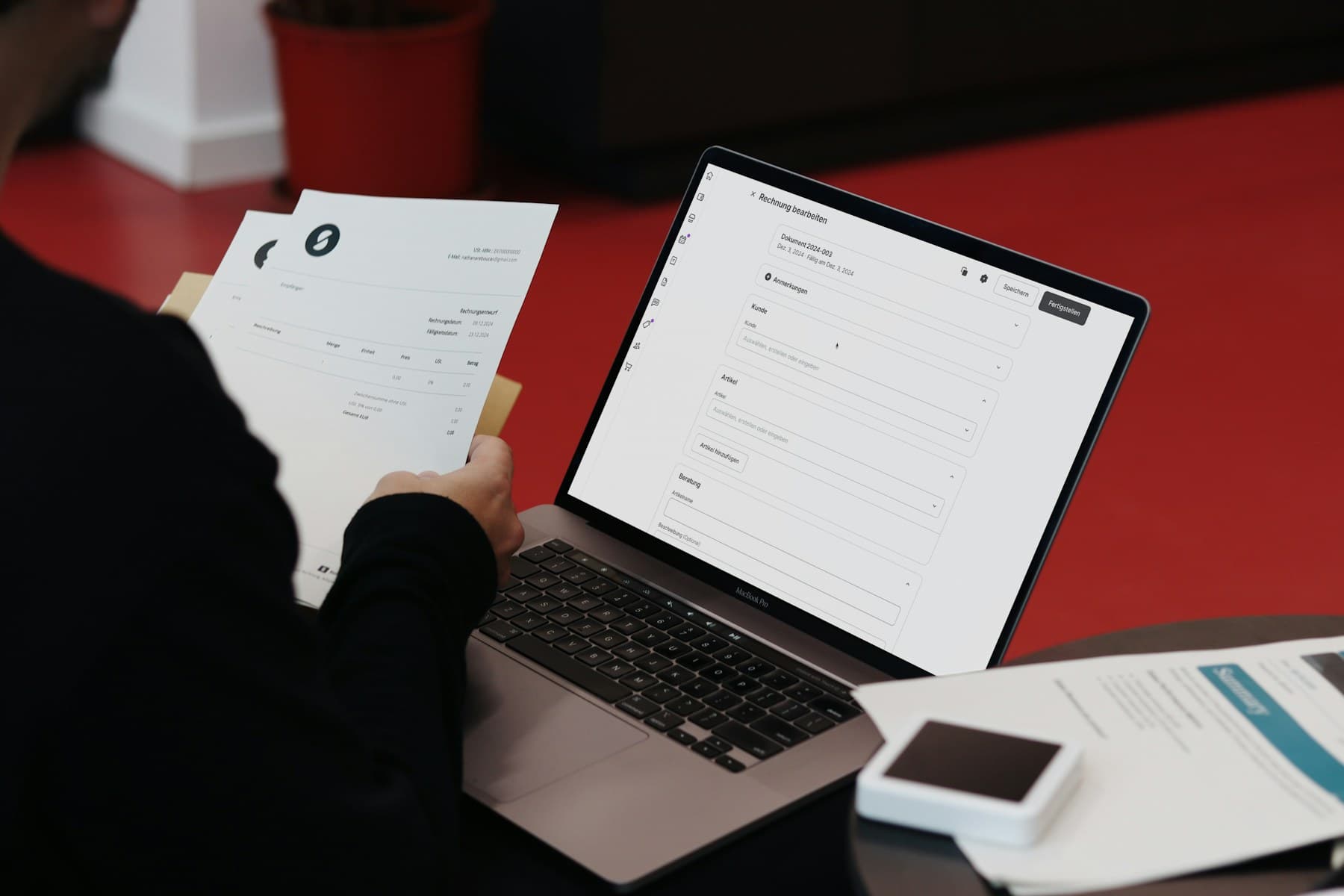 Small business professional reviewing an invoice at a workspace
